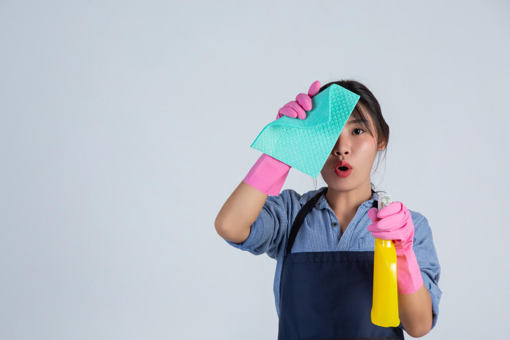 young housewife is wearing yellow gloves while cleaning with product clean white wall 1