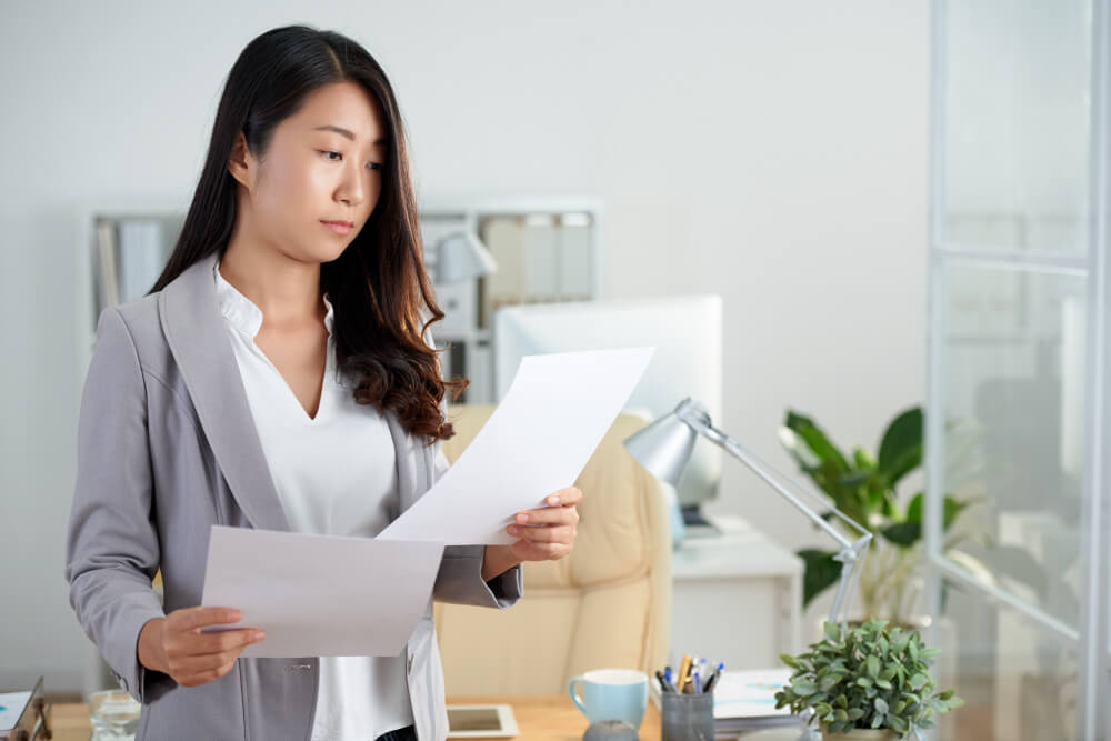 medium shot asian woman checking business documents